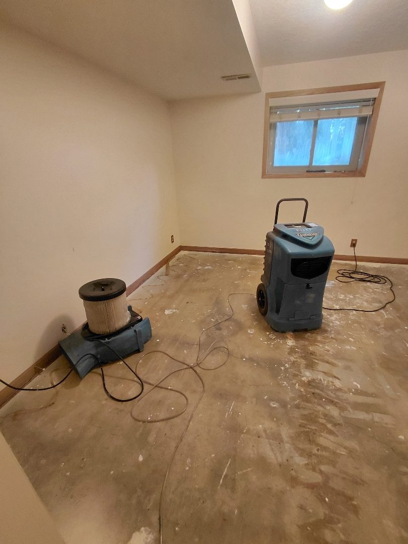 Sandy Residential Dry-Out — Arrival — moisture meter reading on a wet baseboard