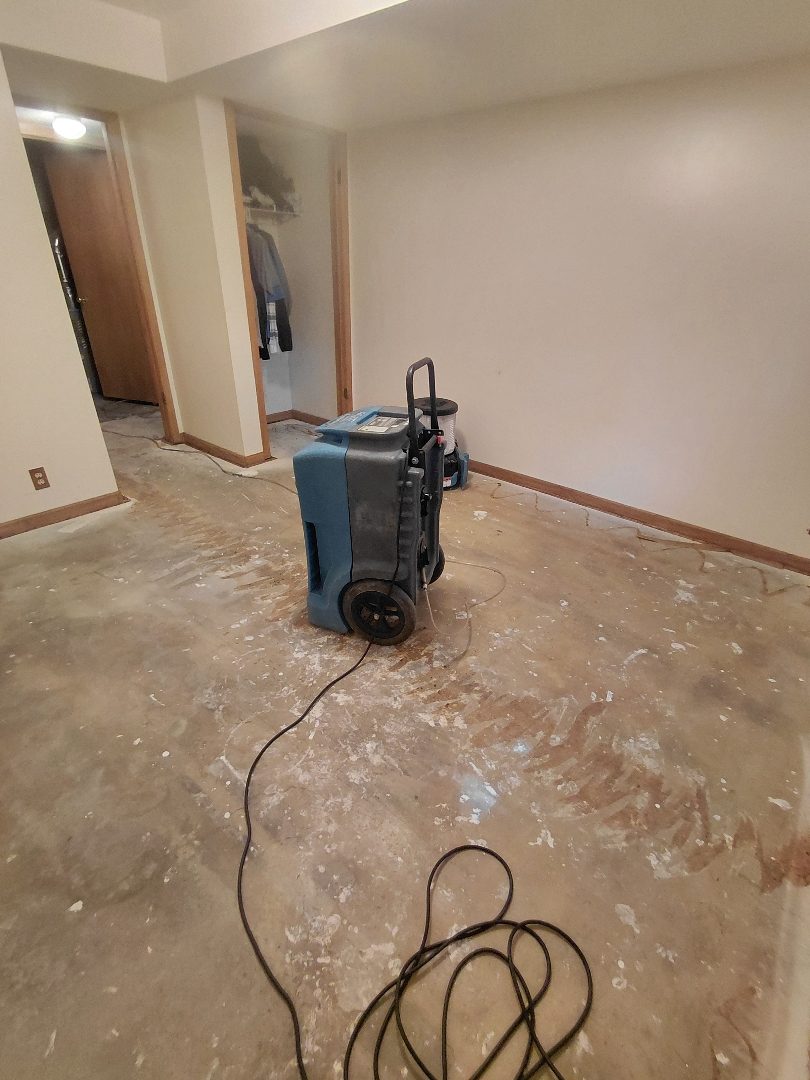 Drying — dehumidifier running on the cleared floor